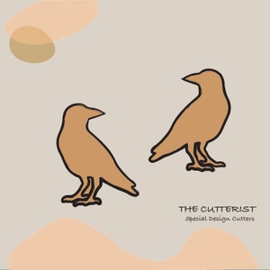 May include: Two brown silhouette birds with black outlines on a light grey background. The text "THE CUTTERIST" and "Special Design Cutters" is below the birds.