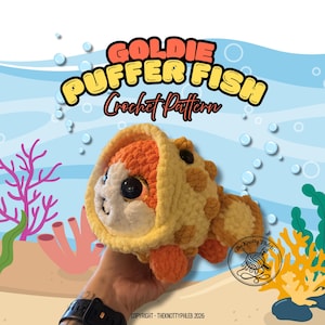 May include: A plush, crocheted puffer fish toy featuring a round body with orange and cream-coloured yarn, large dark eyes, and textured bumps. The image includes the text GOLDIE PUFFER FISH Crochet Pattern and copyright information.