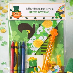 May include: A clear cellophane bag filled with St. Patrick's Day themed items. Includes crayons, a ribbon, and a bubble wand. The bag has a decorative header with a leprechaun and the text "A Little Lucky Fun for You! HAPPY ST. PATTY'S DAY!"