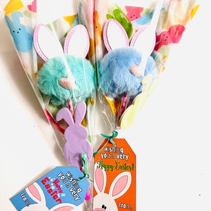 May include: Two Easter bunny pencil toppers with fluffy tails, wrapped in colorful tissue paper with a tag that reads "Wishing you a very Happy Easter!" from,