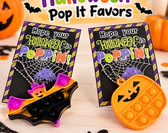 May include: Two silicone fidget keychains with ball chains attached to rectangular cards. One keychain is a black, orange, and purple bat, and the other is an orange pumpkin. The cards feature a spiderweb design and the text Hope your HALLOWEEN is POPPIN!