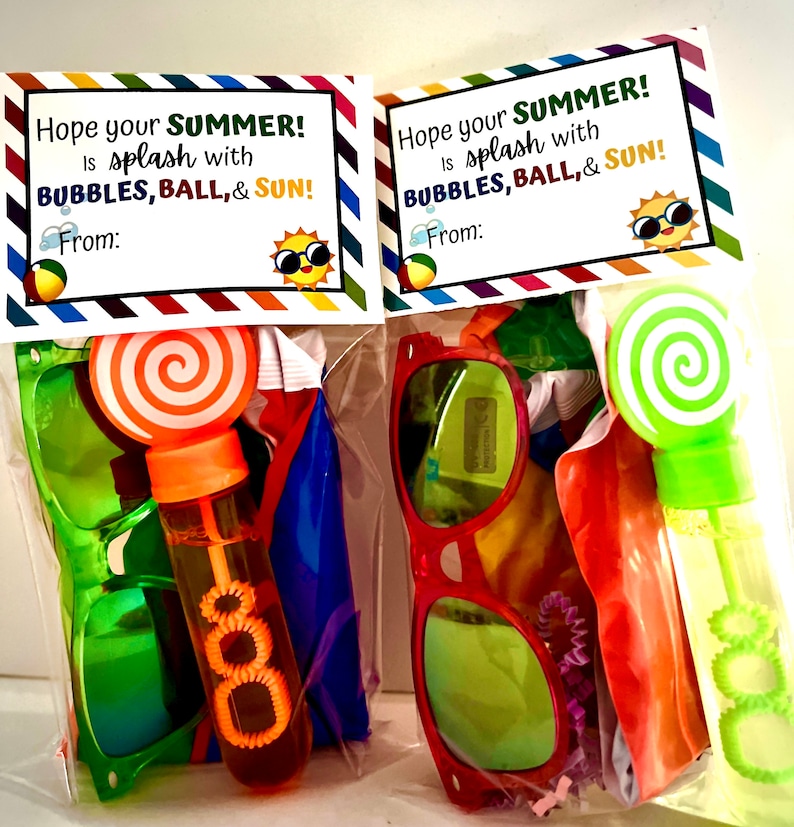 May include: Two clear plastic bags filled with summer themed party favors. Each bag has a card with the text "Hope your SUMMER! is splash with BUBBLES, BALL, & SUN!" and the word "From:" with a blank space for a name. The bags contain sunglasses, a bubble wand, a beach ball, and a lollipop.