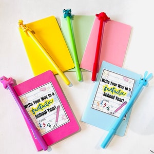 May include: Five colorful notebooks with animal-shaped pens. Each notebook has the text "Write Your Way to a fantastic School Year!" and "Love, 1234" written on the front.