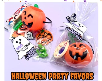 May include: Orange Halloween party favors, including a pumpkin-shaped container, a bag with a pumpkin and eyeball-shaped toys, and a ghost-shaped tag that says "Boo, Here's a TREAT for you! Happy Halloween".
