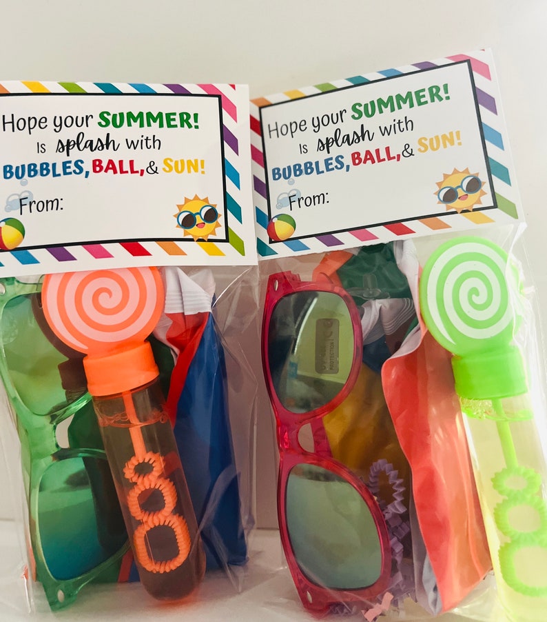 May include: Two clear plastic bags filled with summer-themed party favors. Each bag contains a pair of sunglasses, a bubble wand, a beach ball, and a note that says "Hope your SUMMER! is splash with BUBBLES, BALL, & SUN!"
