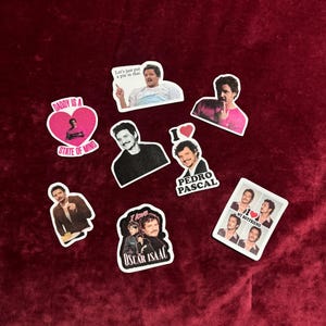 May include: A collection of die-cut stickers featuring images of actors and phrases. The stickers include images of Pedro Pascal and Oscar Isaac, with phrases like "Daddy is a State of Mind" and "I love Oscar Isaac."