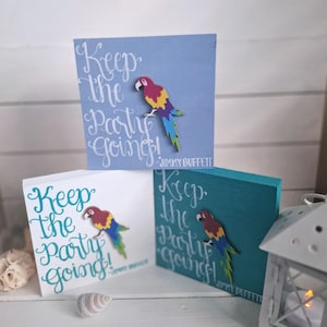 May include: Three wooden signs with the text "Keep the party going!" and a parrot cutout. The signs are painted in blue, white, and teal.