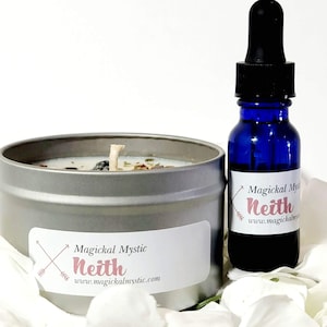 May include: A silver candle tin with a white candle and a crystal inside. The label reads "Magickal Mystic Neith www.magickalmystic.com". A blue glass bottle with a dropper and a label that reads "Magickal Mystic Neith www.magickalmystic.com" is next to the candle.