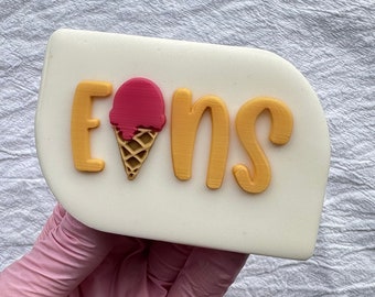 Un sello de fondant para grabar helado con letras