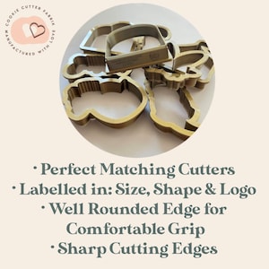 May include: A collection of gold-colored cookie cutters in various shapes, including a mug, cloud, and other designs. The cutters are labeled with size, shape, and logo information. The image also includes text that says "COOKIE CUTTER FABRIK MANUFACTURED WITH LOVE."