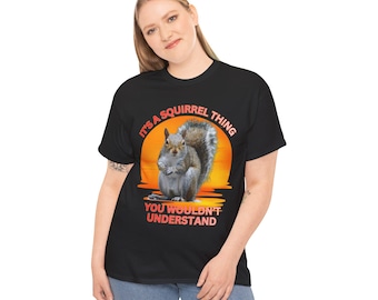 May include: Black t-shirt with a graphic of a squirrel sitting on a sunset background. The text "It's a squirrel thing you wouldn't understand" is printed on the shirt.