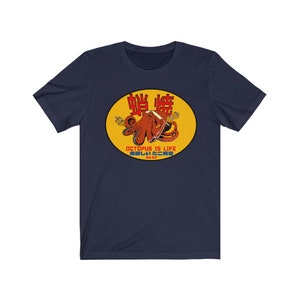 May include: A navy blue t-shirt with a yellow circle graphic featuring a red octopus holding a book. The text "Octopus is Life" and Japanese characters are printed in red on the graphic.