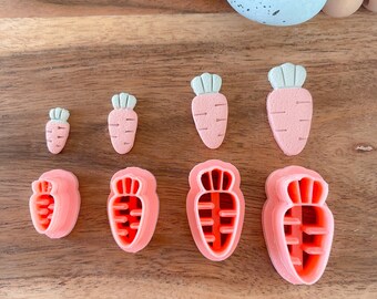May include: A set of seven pink plastic carrot cookie cutters of varying sizes. The cutters are arranged in a row on a wooden surface.