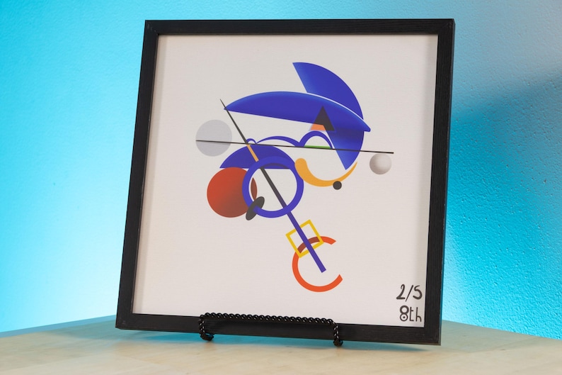May include: A square framed print featuring a white background with abstract geometric shapes in blue, orange, red, and grey. The composition includes circles, lines, and a square. The bottom right corner displays the handwritten text 2/5 8th.