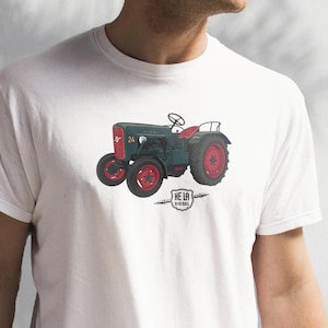 May include: A white t-shirt with a green and red tractor illustration. The tractor has the number 24 on the side and the words "HE LA DIESEL" underneath.