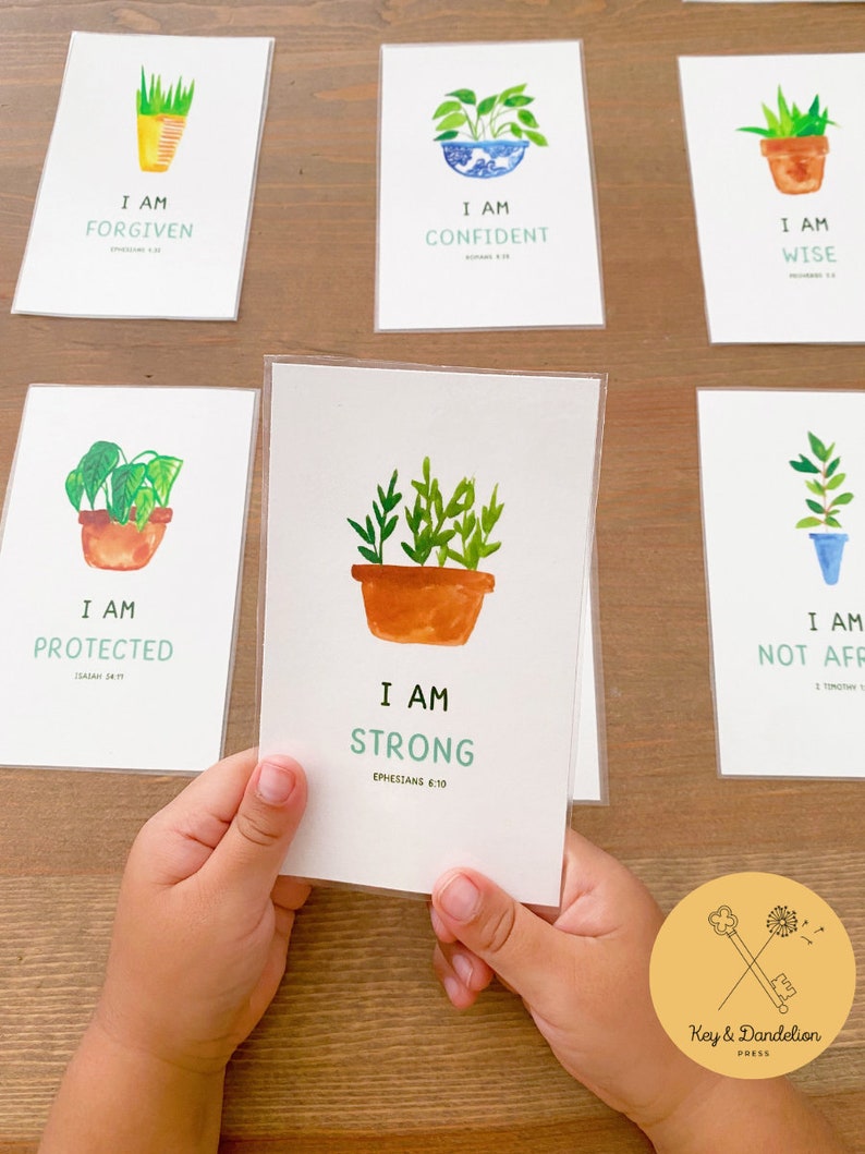 May include: Set of 6 affirmation cards with watercolor illustrations of potted plants. Each card features a positive affirmation and a bible verse. The cards are printed on white cardstock and have rounded corners.
