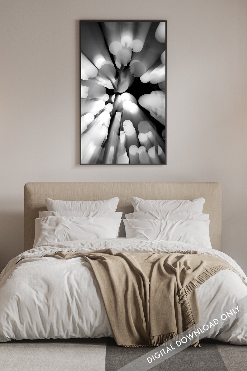 May include: Black and white abstract photograph of a blurred, circular pattern. The image is taken from a low angle, looking up at a series of round objects.