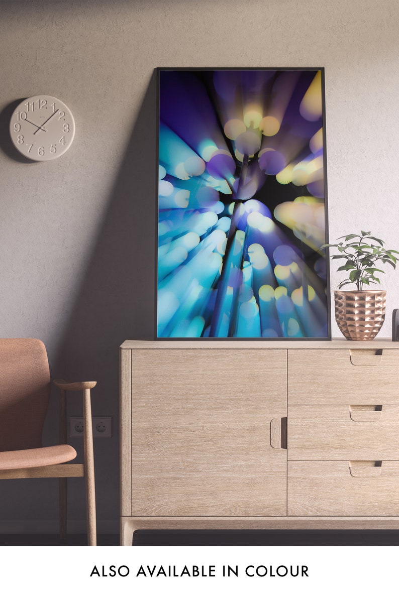 May include: A framed abstract art print with a blue, purple, and yellow color scheme. The print features a blurred, circular pattern of light.