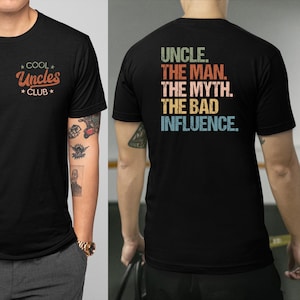 May include: Black t-shirt with a vintage-style graphic that reads "UNCLE. THE MAN. THE MYTH. THE BAD INFLUENCE." The front of the shirt has a smaller graphic that reads "*COOL* Uncles *CLUB*"