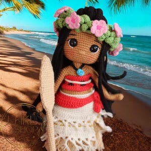 May include: A crocheted doll with brown skin, black hair, and a flower crown. She is wearing a red and white dress and holding a wooden surfboard. The doll is standing on a beach with blue water and white sand.