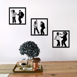 May include: Three black and white silhouette wall art pieces depicting a couple dancing. The art is framed in black and mounted on a white wall.
