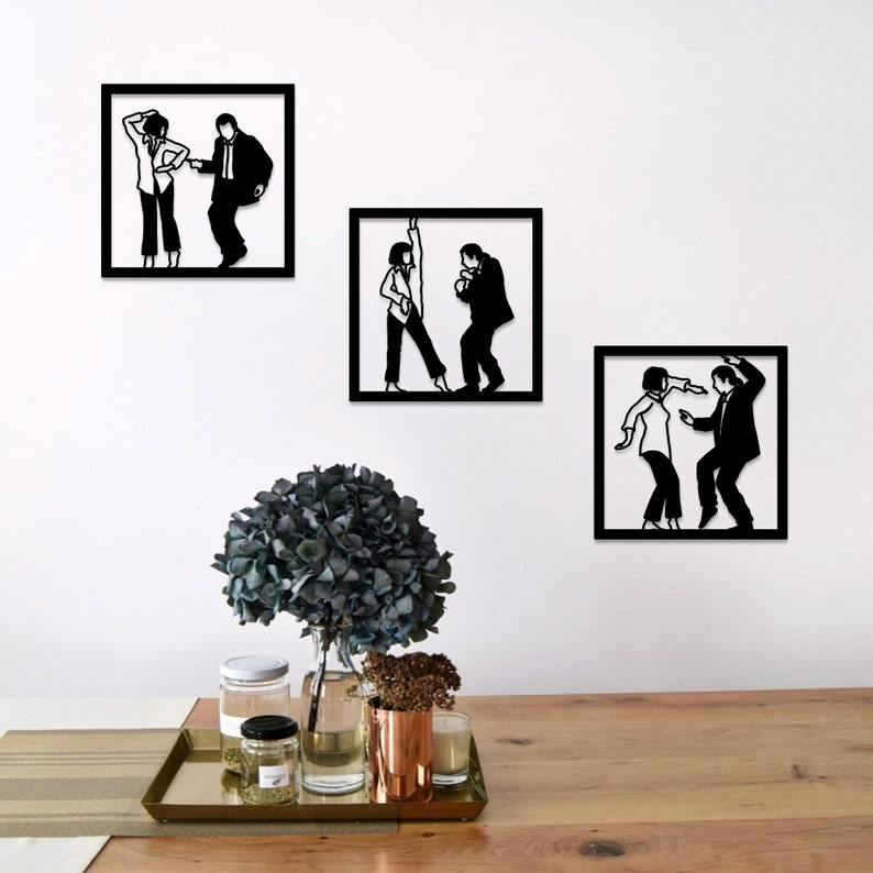 May include: Three black and white silhouette wall art pieces depicting a couple dancing. The art is framed in black and mounted on a white wall.