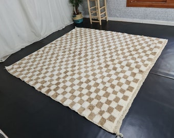 May include: A white and brown checkered rug with a fluffy texture. The rug is made of wool and has a modern design.
