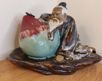 Vintage Shiwan Chinese Mudman Lying On Large Fruit