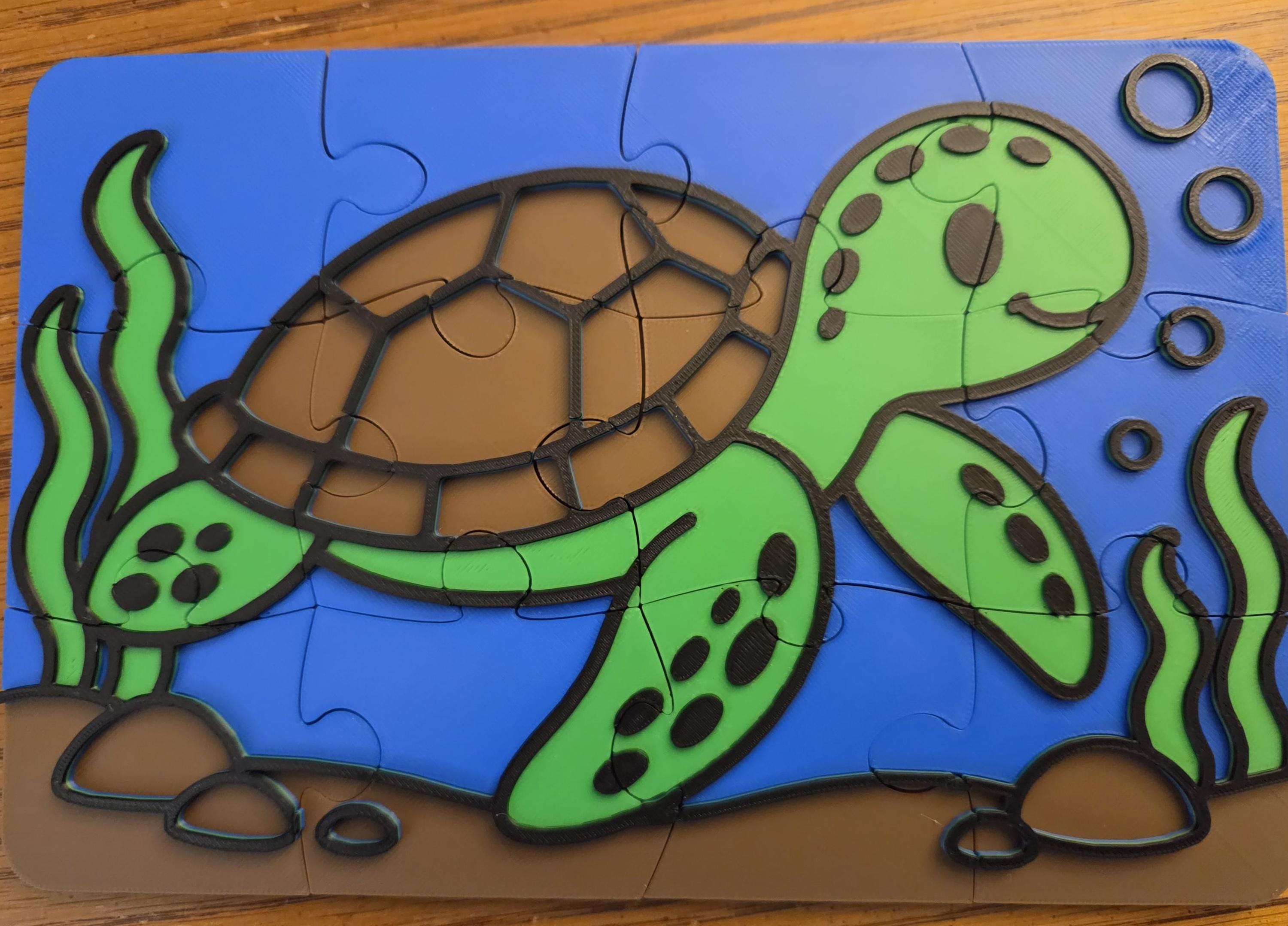 Assembled 12-piece puzzle of a smiling green sea turtle with a brown shell swimming through blue water, with seaweed, rocks and bubbles. Raised black outlines trace every shape.
