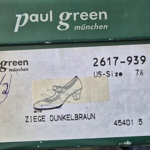 May include: A green shoe box with the brand name "paul green m&uuml;nchen" printed in white. The box has a label with a shoe illustration and the text "ZIEGE DUNKELBRAUN". The US size is 7 1/2.