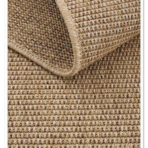 May include: Close-up of a woven rug with a brown and beige color scheme. The rug has a textured surface and a stitched edge.
