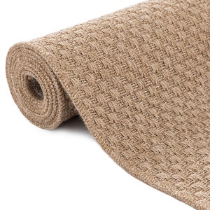 May include: A rolled up tan woven rug with a textured surface.