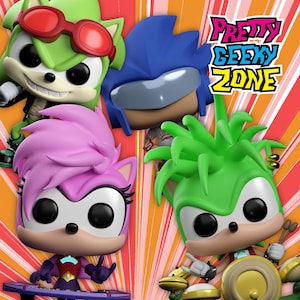 May include: Four stylized vinyl figures featuring large heads and black eyes. One green character wears red goggles, one blue character has a visor, one pink character plays a keyboard, and one green character plays drums. Text reads Pretty Geeky Zone.