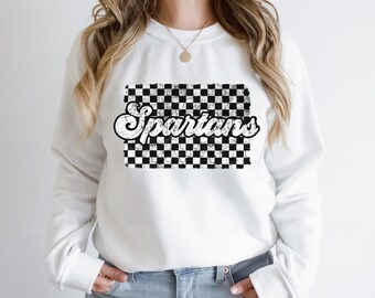 May include: White sweatshirt with a black and white checkered pattern and the word "Spartans" in a retro font.