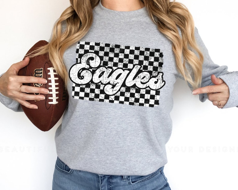 May include: Gray sweatshirt with a black and white checkered design and the word "Eagles" in a retro font.