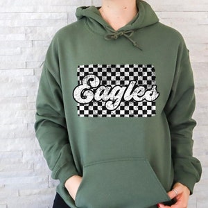 May include: A green hooded sweatshirt with a white checkered background and the word "Eagles" in a retro font.