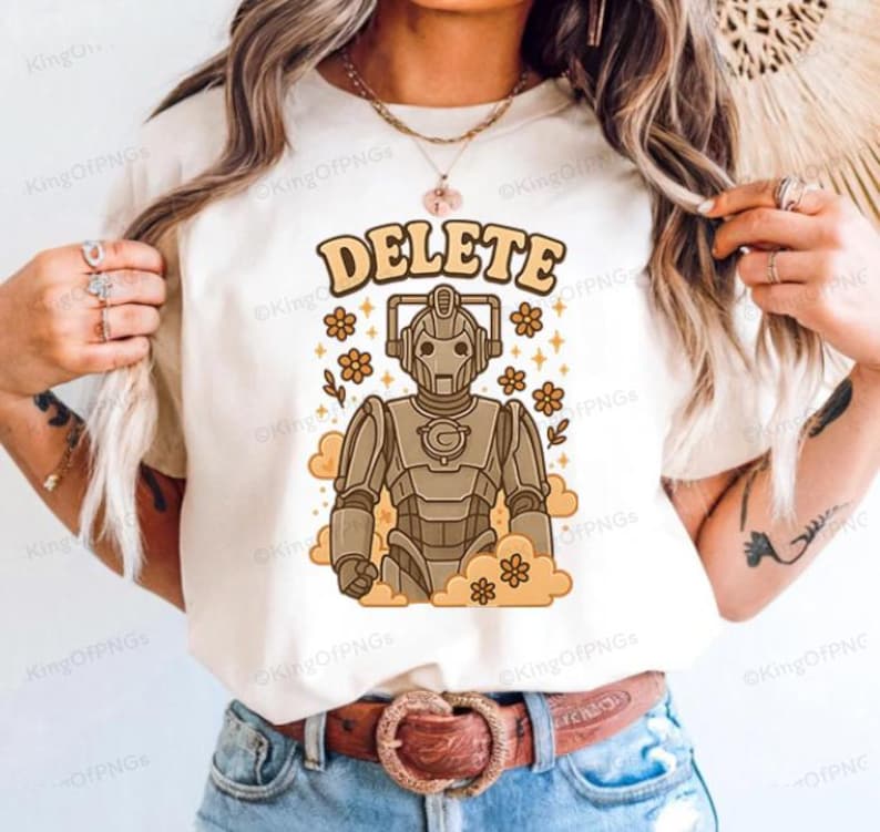 A person wearing a white t-shirt with a graphic design of a robot character and the word "DELETE" printed on it.