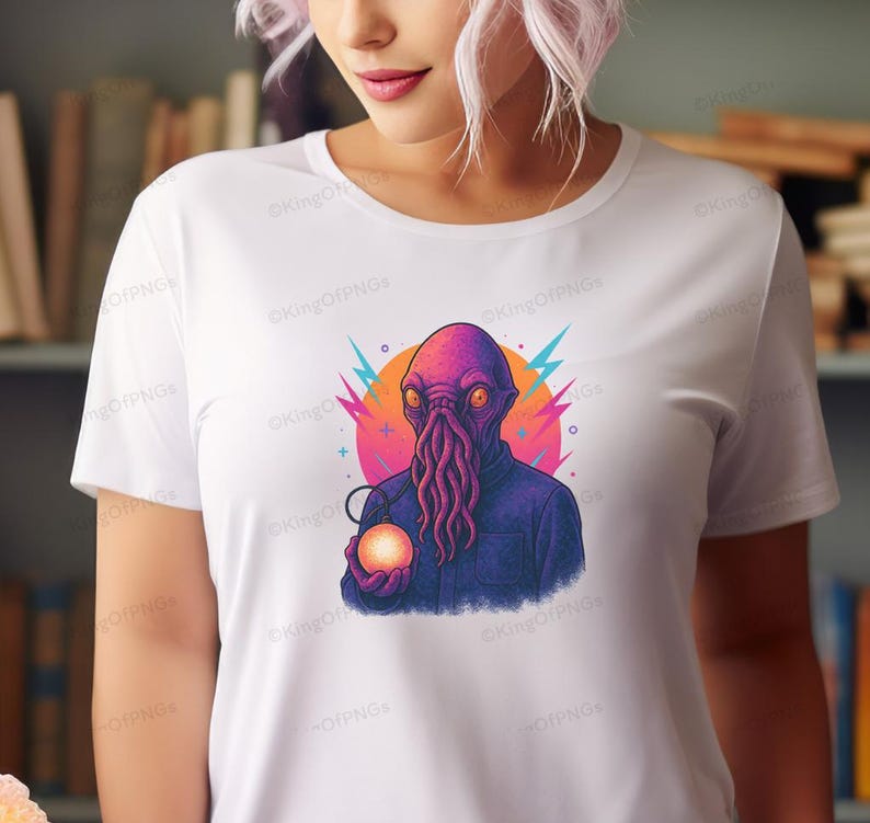 A woman wearing a white t-shirt with a colorful graphic of an alien-like creature holding a glowing orb.