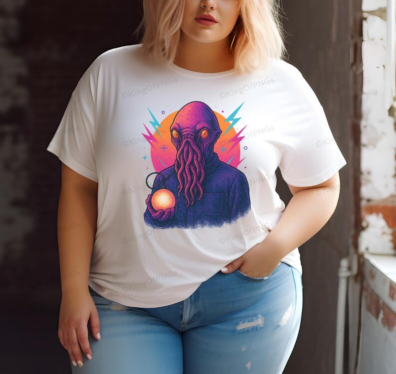 A woman wearing a white t-shirt with a colorful graphic of an alien-like creature holding a glowing orb.