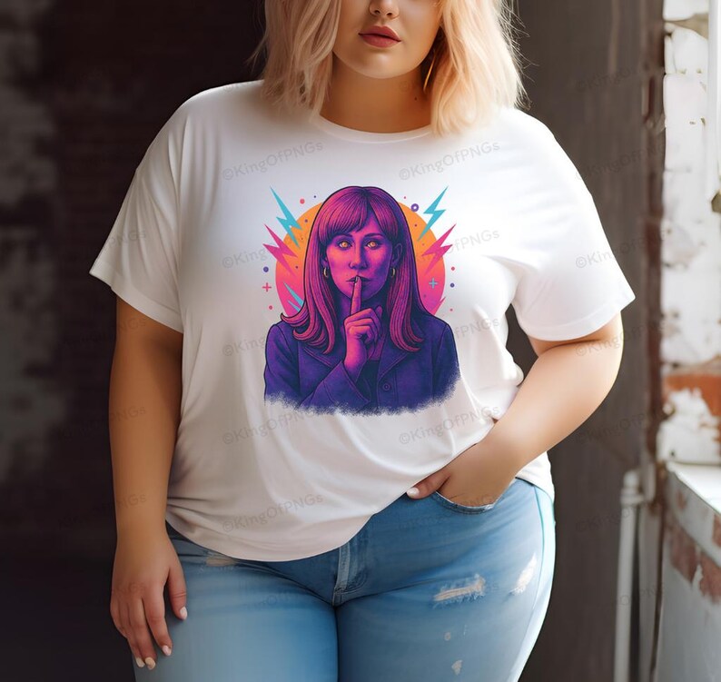A woman wearing a white t-shirt with a colorful graphic of a woman with long hair and a purple jacket.