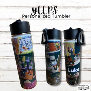 May include: Three personalized tumblers with black lids and colorful cartoon graphics. The tumblers feature the text "YEEPS Personalized Tumbler" and "Hide & Seek". One tumbler has the name "Luke".