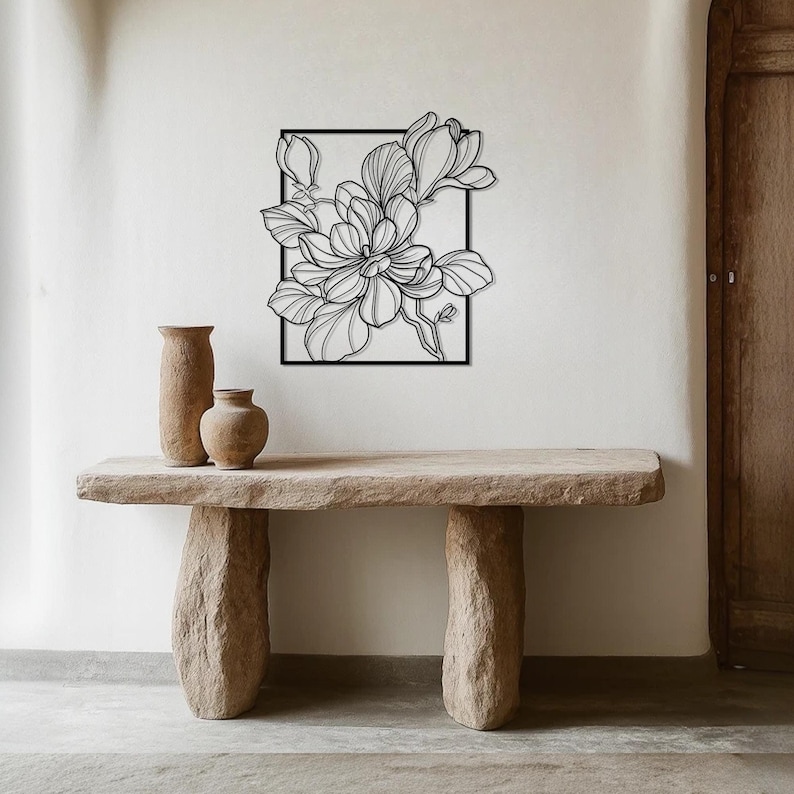 black magnolia wall art on the white wall