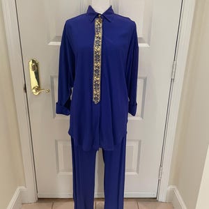 May include: A royal blue pantsuit with a gold and blue patterned trim down the front of the shirt.