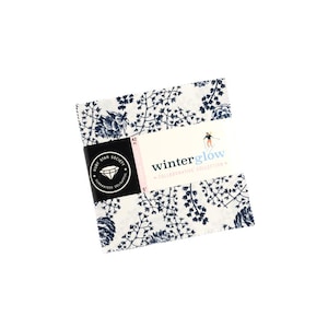 May include: A white fabric square with a blue floral pattern. The fabric is part of the "winterglow" collaborative collection by Ruby Star Society. The fabric measures 5 inches by 5 inches.