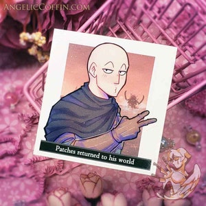 May include: A sticker featuring a cartoon character with a bald head and a serious expression. The character is wearing a dark blue cloak and has a light brown hand. The background is a sunset with a silhouette of a creature in the distance. The text "Patches returned to his world" is at the bottom of the sticker.