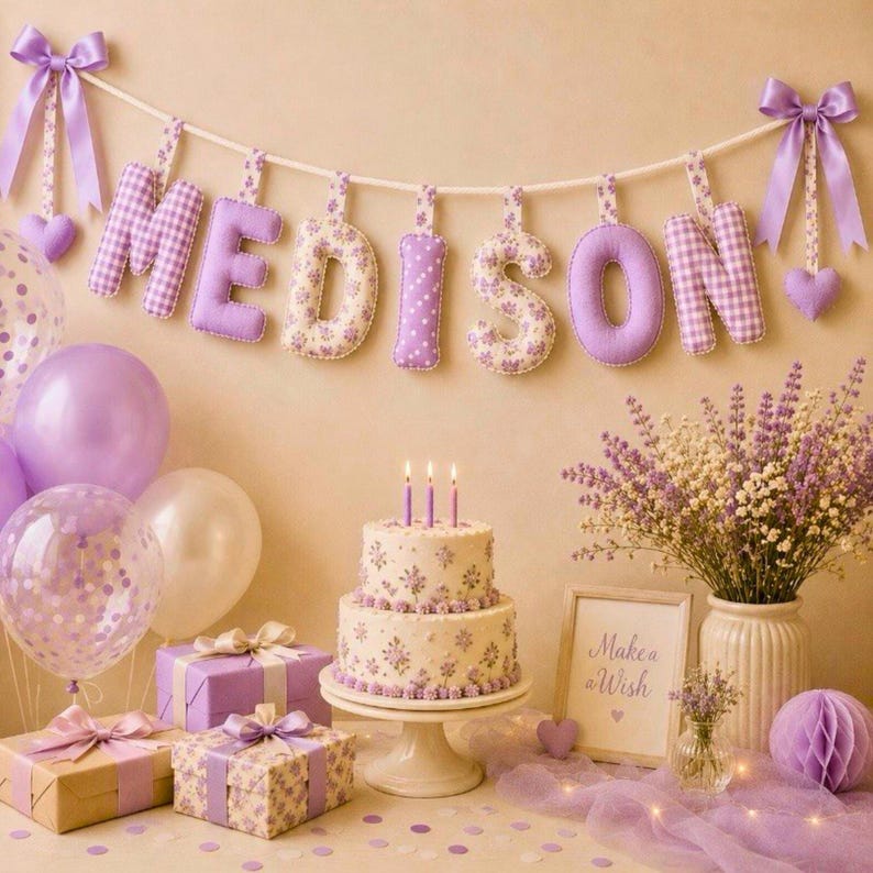 May include: A festive birthday scene with a banner spelling "MEDISON" in purple and floral fabric letters. A two-tiered cake with candles, gifts, balloons, and flowers in shades of purple and white create a celebratory atmosphere.
