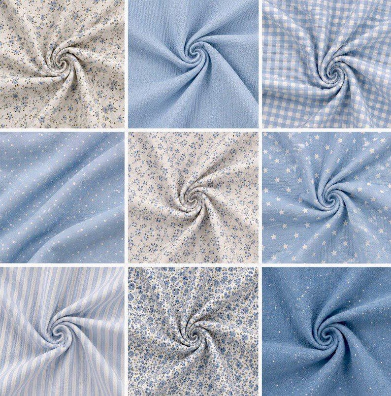 May include: Nine swatches of fabric in various light blue and white patterns. Designs include small floral prints, polka dots, gingham, stripes, and star patterns. The fabrics are swirled to show texture and drape, suitable for sewing or crafting projects.