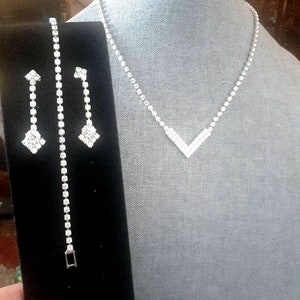Glamorous Rhinestone 3 piece jewelry set. Includes necklace, Bracelet, and earrings. Dangle/drop Statement earrings