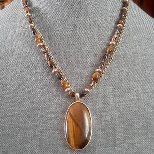 Monet Tiger&#39;s eye style detachable pendant multi strand gold tone necklace.