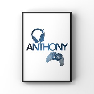 May include: A white poster with a black frame featuring a blue and black illustration of a gaming headset and a video game controller. The name "ANTHONY" is printed in blue and black letters.